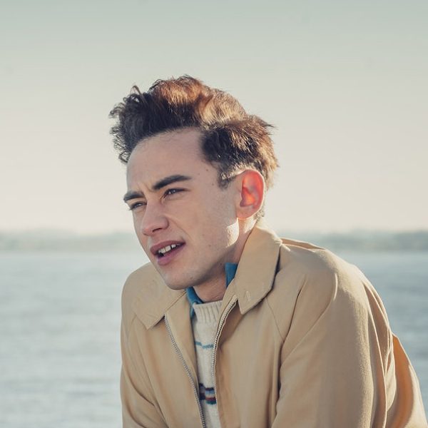 olly alexander 80s bouffant curly cropped hairstyle
