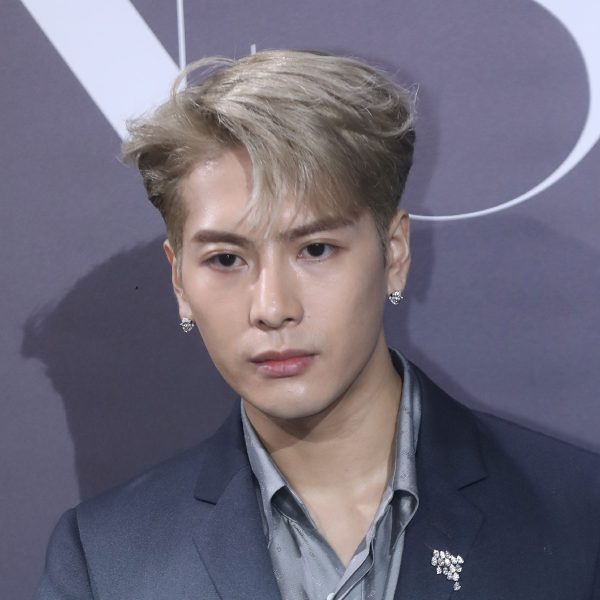 Jackson Wang: Bleached Blonde Side Parted Medium Length Hairstyle